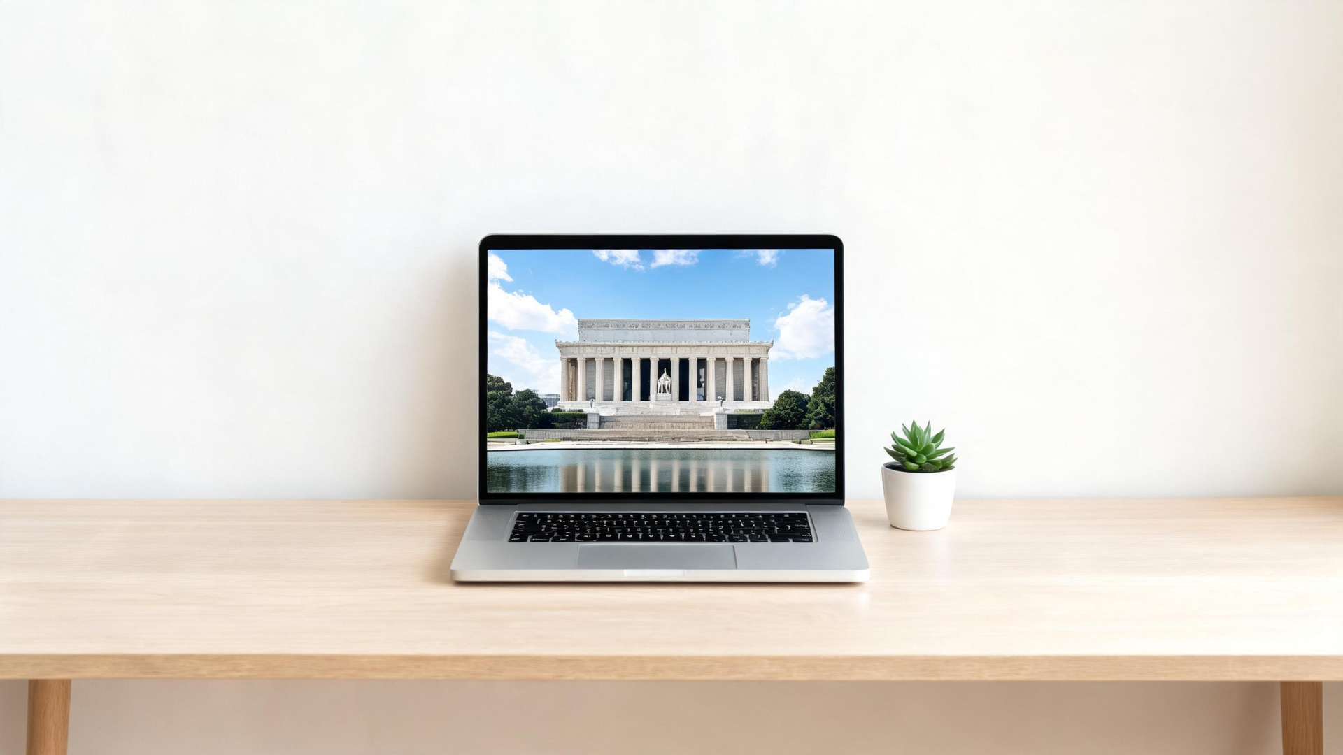 Laptop showing images of a national memorial during a virtual tour on a desk
