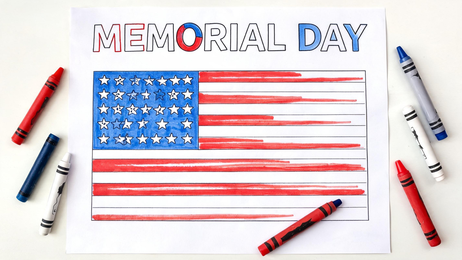 Memorial Day coloring pages with flags and stars alongside crayons on a flat surface