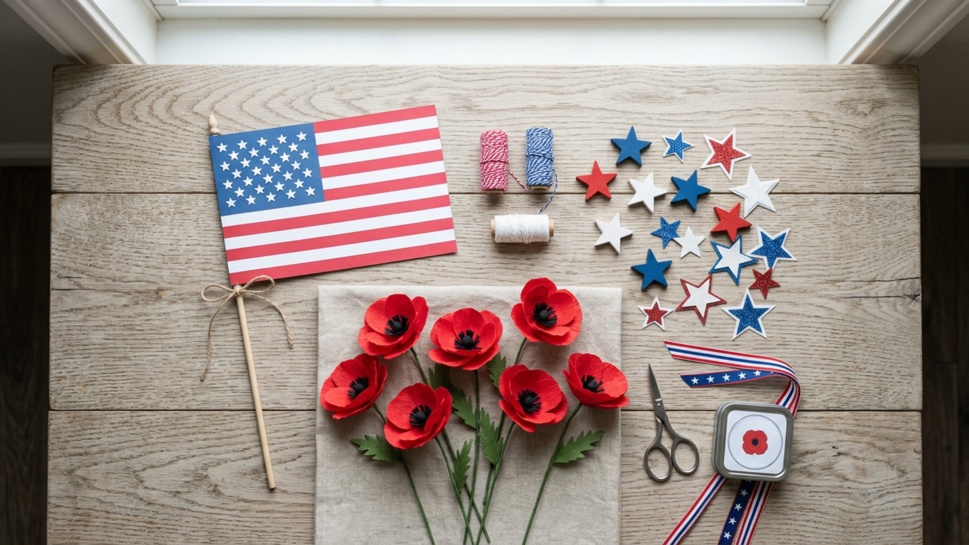 Memorial Day crafts with flag poppy and star decorations arranged on a clean light wooden surface