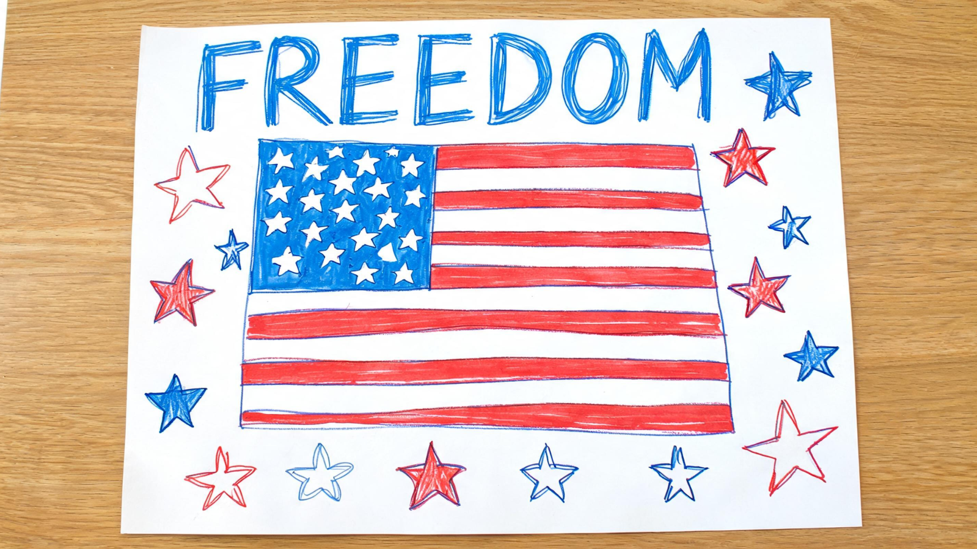 Memorial Day poster with drawings of flags and stars created using markers on paper