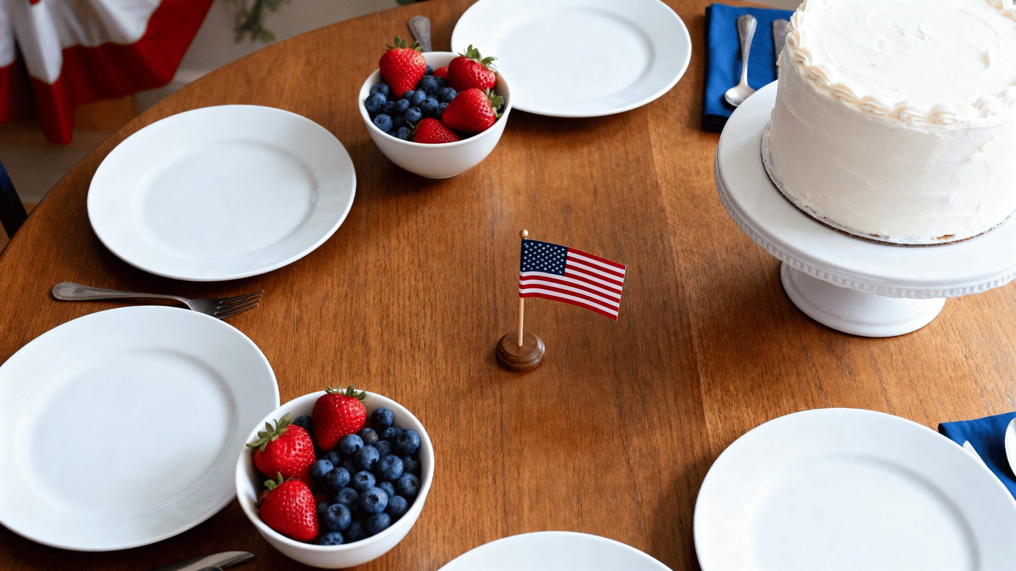 Memorial Day table with red white blue food and simple decor setup.