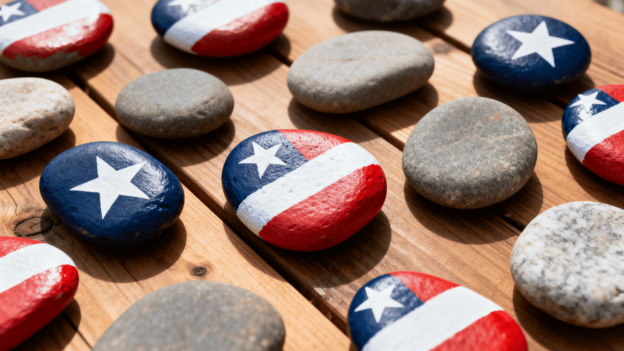 Painted rocks with patriotic designs on table