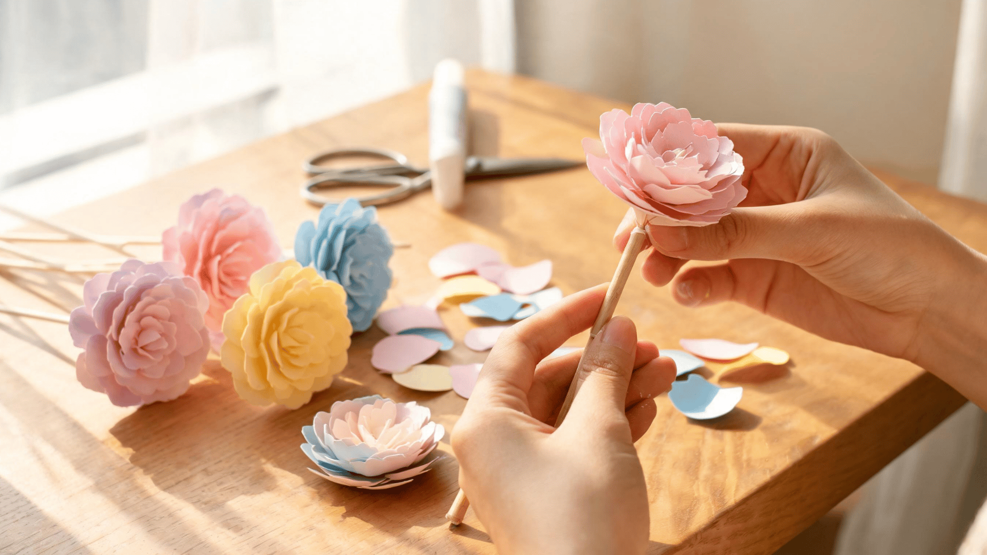 Paper flowers attached to wooden stems during handmade bouquet creation. (1)