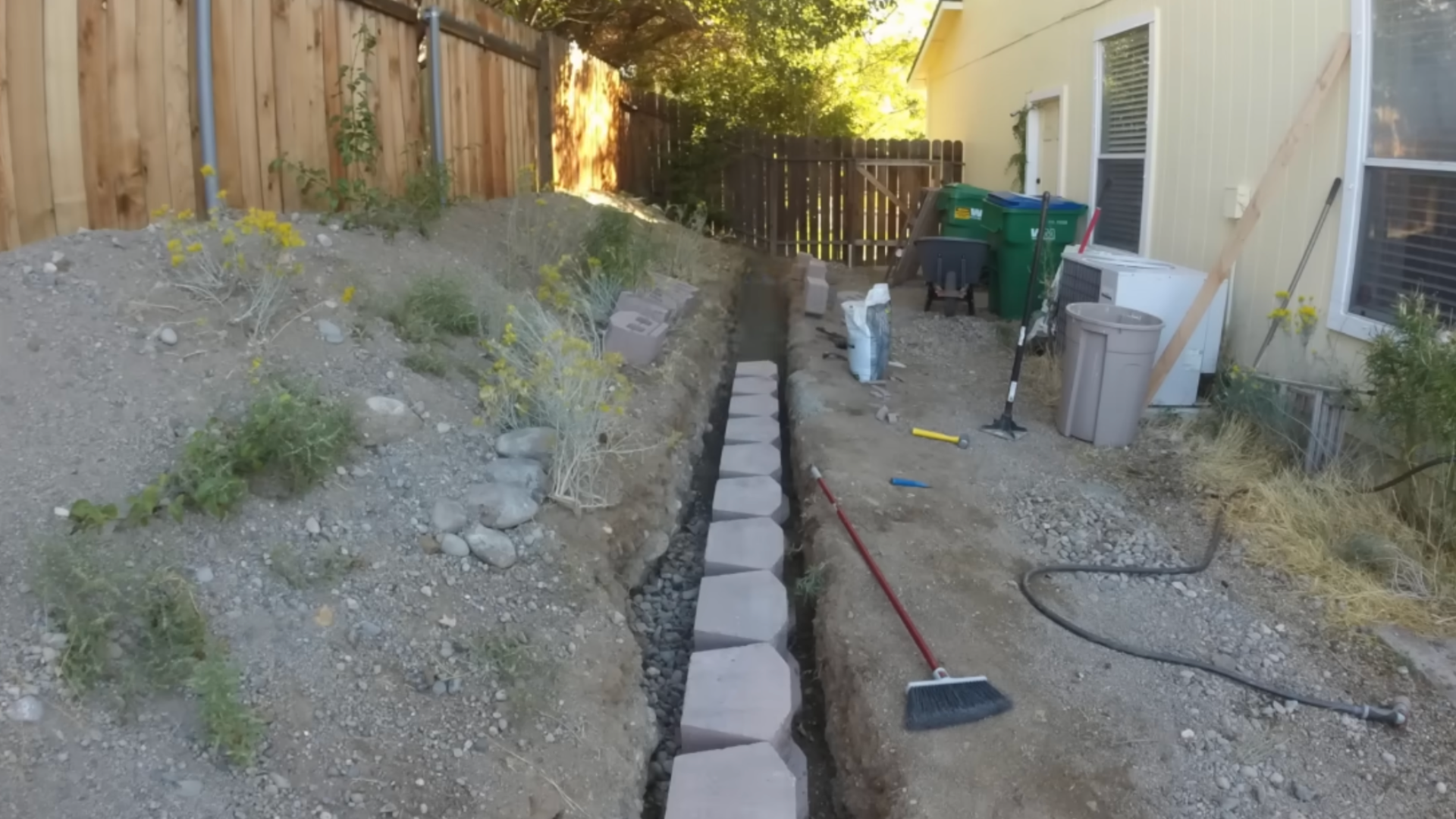 Placing and leveling first row of retaining wall blocks carefully to ensure proper alignment and stability