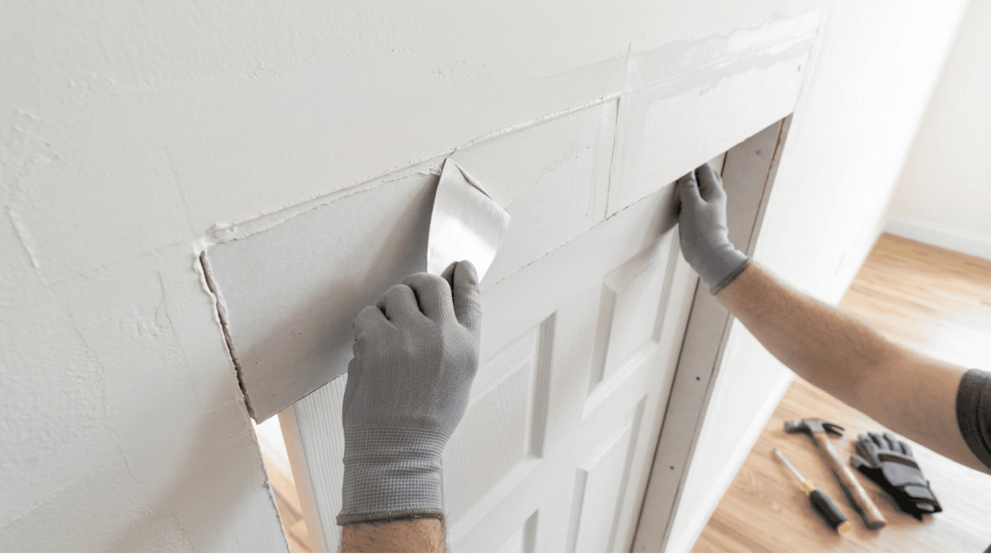 Repairing drywall around the newly installed pocket door frame