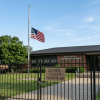 School building closed on Memorial Day with flag and calendar showing holiday