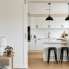 White sliding pocket door between living room and bright modern kitchen