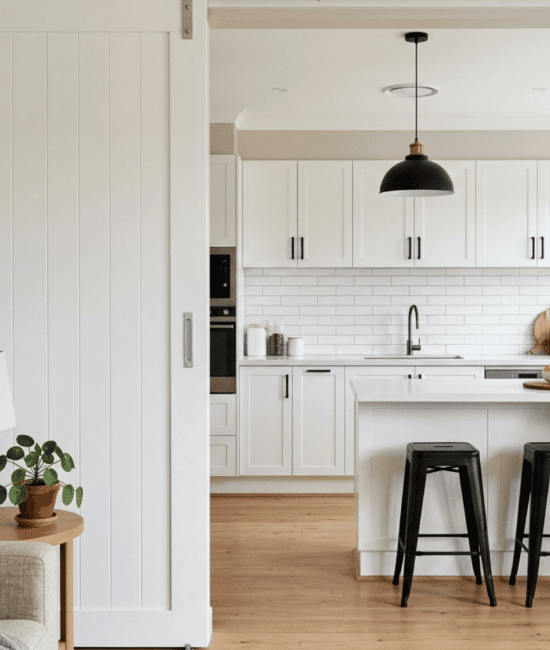 White sliding pocket door between living room and bright modern kitchen