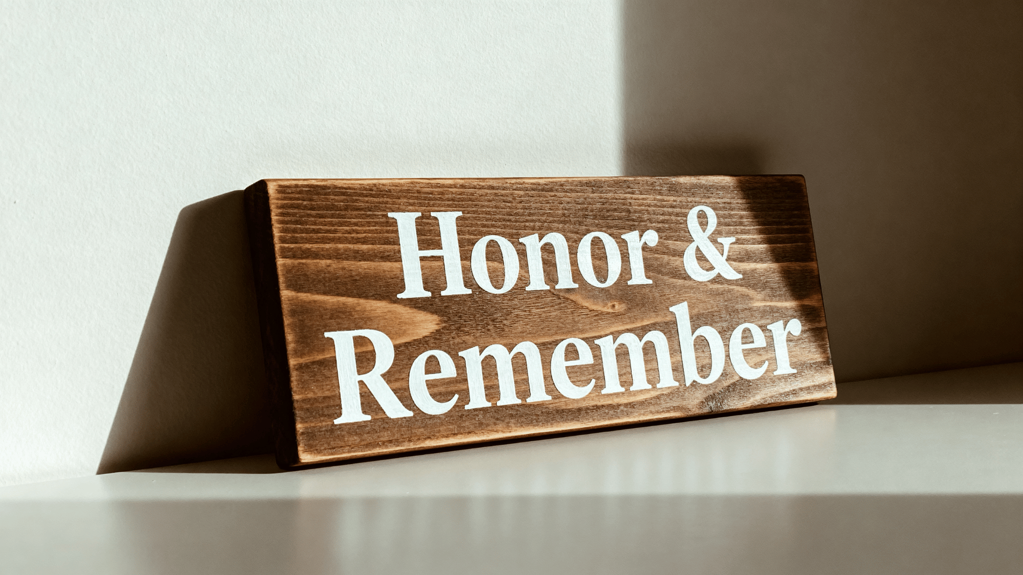 Wooden sign with Honor and Remember message