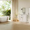 Modern bathroom with freestanding bathtub and white double vanity near large windows