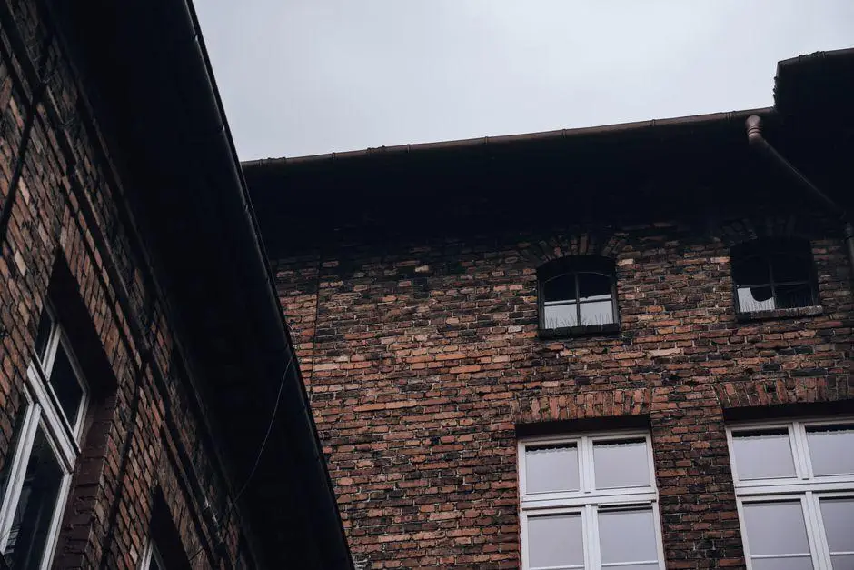 Brick building facade with arched windows under overcast sky