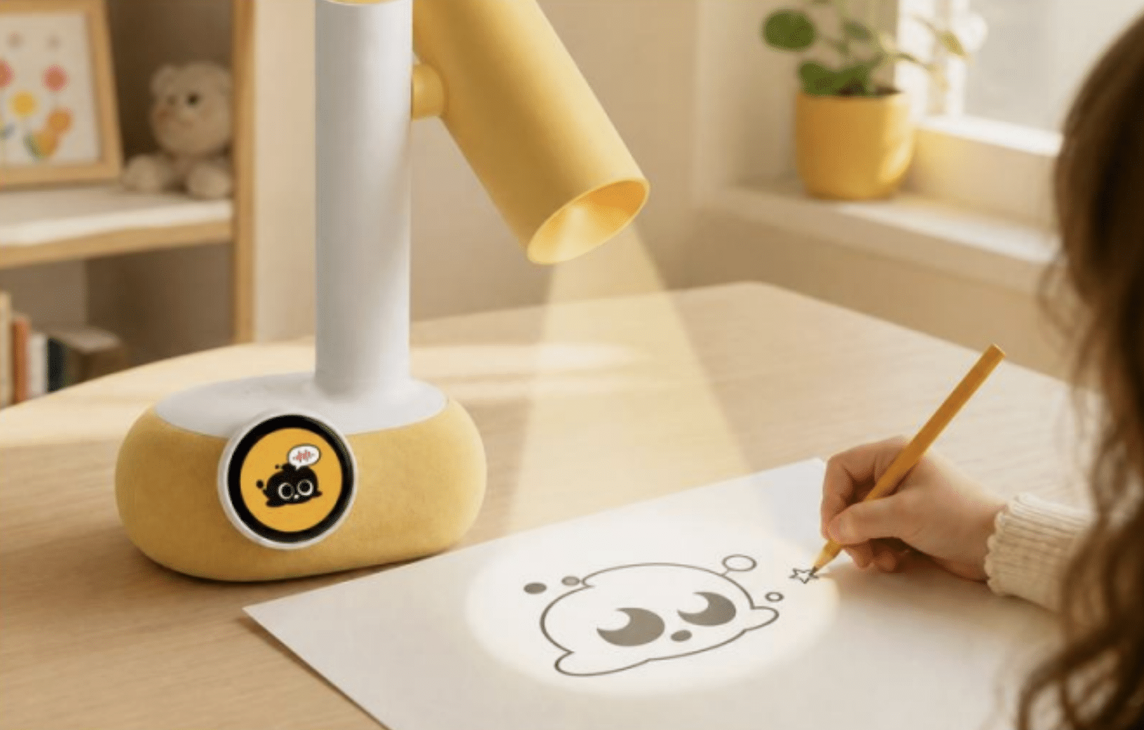 Child drawing cartoon character on paper under yellow desk lamp in cozy room