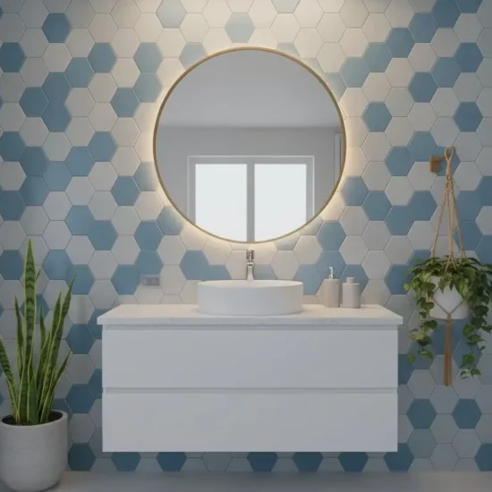 Round mirror with backlighting above modern white basin in bathroom with blue hexagonal tiles